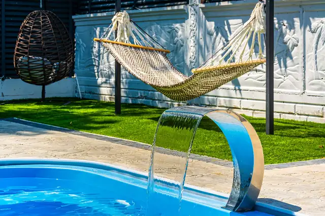 Havuz kenarında hamak, rattan koltuk ve su perdesi